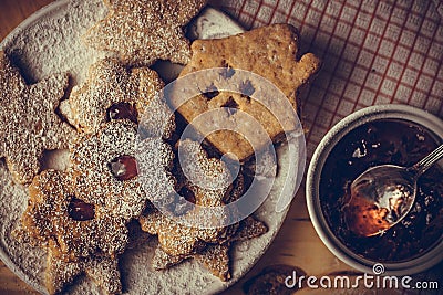 Homemade Christmas gingerbread and linzer cookies with jam, powdered, top flat view, soft haze effect, vintage Stock Photo
