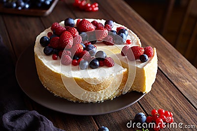 Homemade Christmas winter berry fruit cheesecake on wooden dark table. Creamy mascarpone dessert. Stock Photo