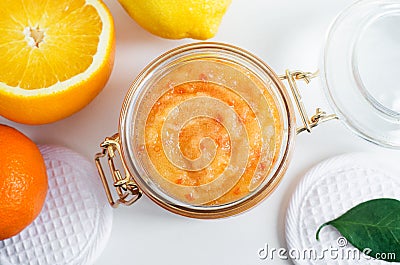 Homemade citrus fruit facial mask exfoliating sugar scrub in the glass jar. Mandarin, orange, lemon DIY cosmetics and spa recipe Stock Photo