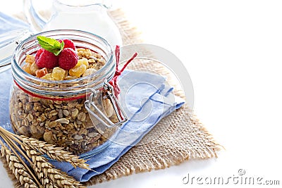 Homemade citrus granola in a glass jar on white Stock Photo