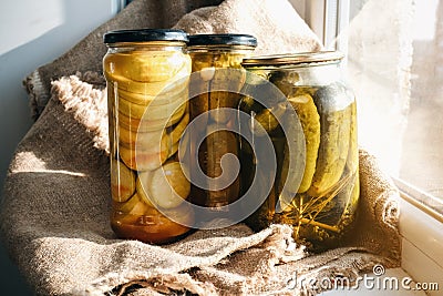 Homemade conservation of zucchini and cucumbers pickled preserved canned in glass jar Stock Photo