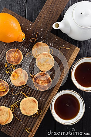 Homemade cookies with lemon zest served with puerh tea on ribbed Stock Photo