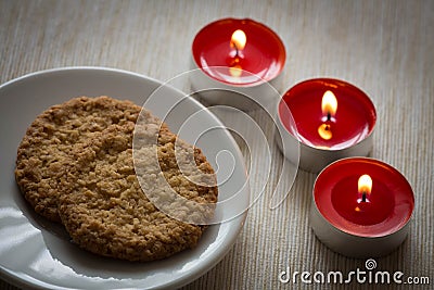Homemade cookies surrounded by candles, hygge time Stock Photo