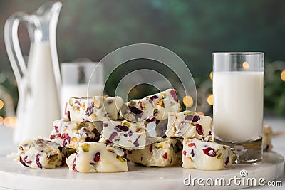 Homemade cranberry and pistachio white chocolate fudge served with milk Stock Photo