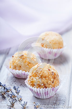 Homemade cream candy dessert on wooden background close up. Delicious praline with decor. Stock Photo