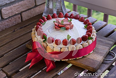 Homemade cream layer cake, fresh, colorful, and delicious dessert with juicy strawberries, sweet whipped cream and cream Stock Photo