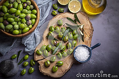 Homemade crushing olive making. Fresh green olives are breaking one by one. Crushing olives with stone. Preparing pickled olives Stock Photo