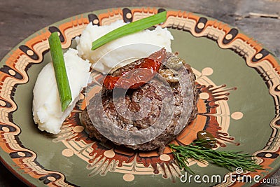 Homemade cutlet with mashed potatoes on a plate on old wooden ta Stock Photo