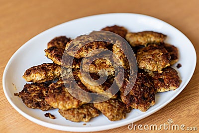 Homemade cutlets,meatballs white plate on a table yellow background.Delicious homemade cutlets.Selective focus Stock Photo