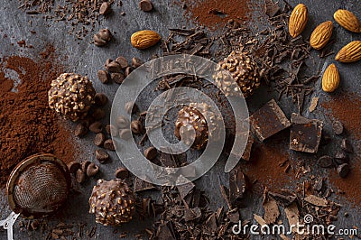 Homemade dark chocolate and almond nuts truffles surrounded by chocolate pieces and cocoa powder Stock Photo