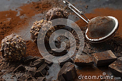 Homemade dark chocolate and nuts truffles surrounded by chocolate pieces and cocoa powder Stock Photo