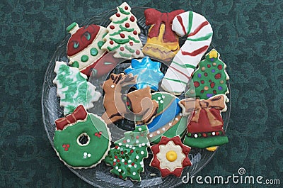 Homemade Decorated Cutout Christmas Cookies On Clear Plate,Green Tablecloth Stock Photo