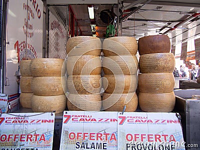 Homemade delicious cheese wheels at an open market for sale Editorial Stock Photo