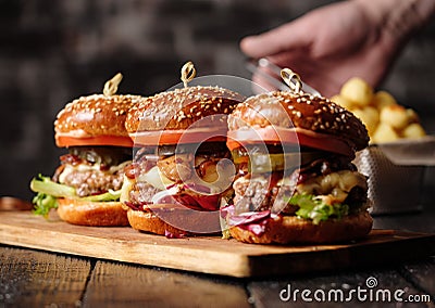 Homemade delicious juicy burger with beef, cheese, tomato and ca Stock Photo