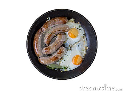 Homemade delicious sausages and fried eggs in a pan Stock Photo