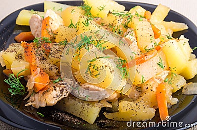 Homemade dish of slices of stewed potatoes, chicken, carrot and Stock Photo