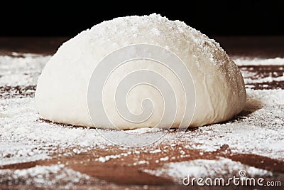 Homemade dough ball for pizza on floured wooden table Stock Photo