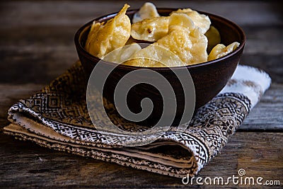 Homemade dumplings in clay pots on the kitchen table, fork and folklor napkin. Stock Photo