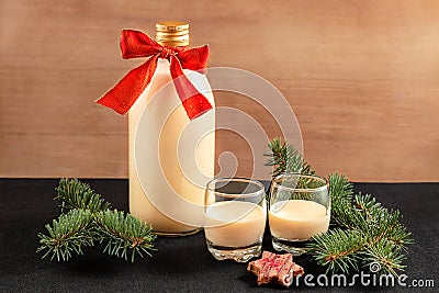 Homemade eggnog in bottle and two glasses with Christmas cookies Stock Photo