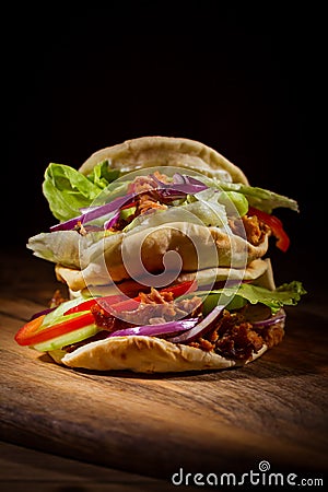 Homemade flatbread sandwich, kebab or doner with chicken meat, lettuce and vegetables Stock Photo