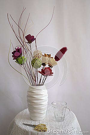 Homemade flower arrangement, handmade colorful flowers in white ceramic vase Stock Photo