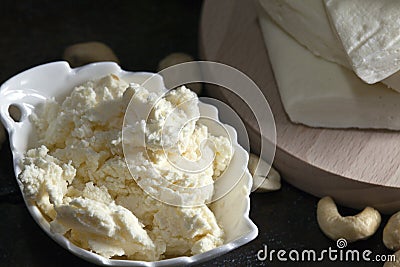 Homemade fresh cheese in the bowl. Macro photography Stock Photo