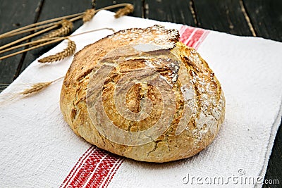 Homemade freshly baked bread on a napkin. Stock Photo