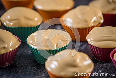 Homemade freshly made cupcakes in silicone molds on dark background. Concept of confectionery cooking Stock Photo