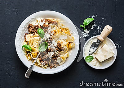 Homemade freshness pappardelle pasta with beef bolognese sauce on a dark background. Stock Photo