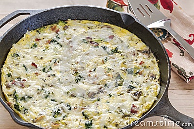 Homemade frittata made with broccoli, bacon, spinach and mushrooms Stock Photo