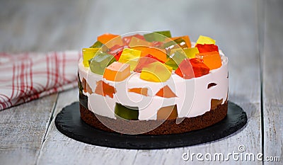 Homemade fruit dairy multi-colored jelly cake on a plate Stock Photo