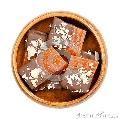 Homemade fruit jelly pieces, with chocolate and almonds, in wooden bowl Stock Photo