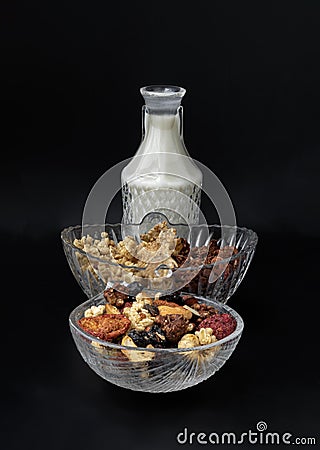Homemade Gadola, Cereal and Nuts in Glass Bowl served with Almond Milk in Black Background Stock Photo