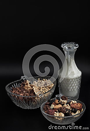 Homemade Gadola, Cereal and Nuts in Glass Bowl served with Almond Milk in Dark Background Stock Photo
