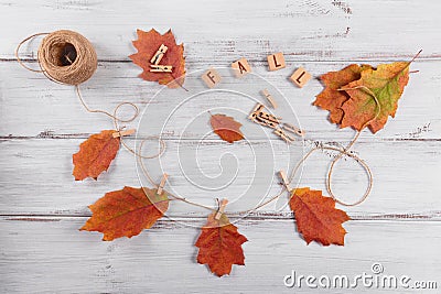 Homemade garland of colored autumn leaves Stock Photo