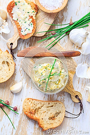 Homemade garlic butter with chives and fresh roasted baguette with salt Stock Photo