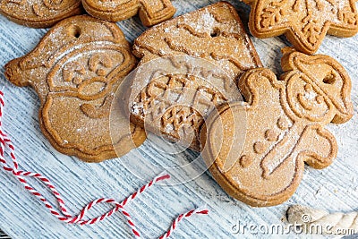 Homemade gingerbread cookies on tray with cup of coffee on grunge gray wooden table. Christmas and New Year celebration Stock Photo