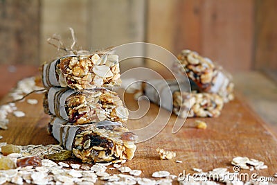 Homemade granola energy bars with figs, oatmeal, almond, dry cranberry, dates, nuts, raisins, sesame and healthy snack Stock Photo