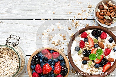 Homemade granola with greek yogurt, nuts and fresh berries in a bowl with cereal in ja Stock Photo