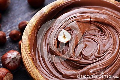 Homemade hazelnut spread in wooden bowl. Hazelnut Nougat cream Stock Photo