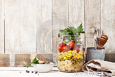 Homemade healthy layer salad in mason jar on a wooden background Stock Photo