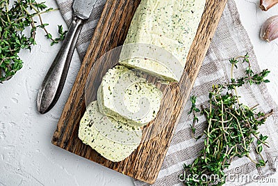 Homemade Herb Butter with garlic, on white stone background Stock Photo