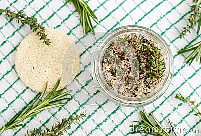 Homemade herbal scrub foot soak or bath salt with rosemary, thyme, sea salt and olive oil. Natural skin and hair care. Stock Photo