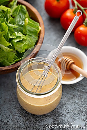 Homemade honey mustard dressing in a glass jar Stock Photo