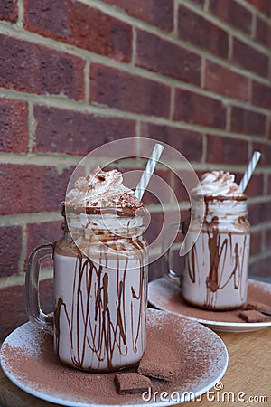 Homemade hot chocolate, with whipped cream and chocolate powder toppings. Stock Photo