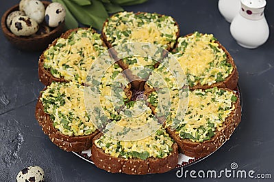Homemade hot sandwiches with green onions, ramson wild garlic, quail eggs, cheese and parsley on dark background Stock Photo