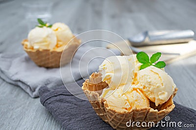 Homemade Ice cream scoops with vanilla ice cream in a bowl with mint leaf Stock Photo