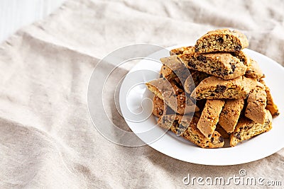 Homemade Italian Cantuccini with Chocolate on a White Plate, side view. Crispy Chocolate Cookies. Copy space Stock Photo
