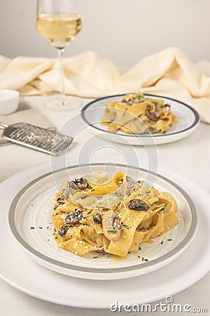 Homemade Italian fettuccine pasta with mushrooms and parmesan Fettuccine al Funghi Porcini. Traditional Italian cuisine. Stock Photo