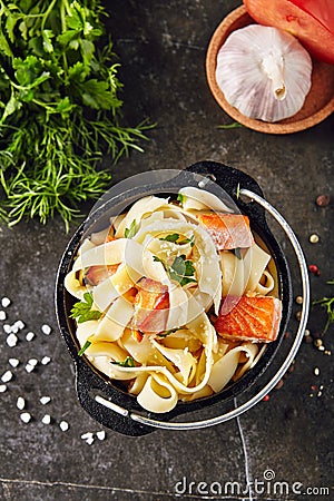 Homemade Italian Tagliatelle Pasta with fried Salmon Fillet Stock Photo